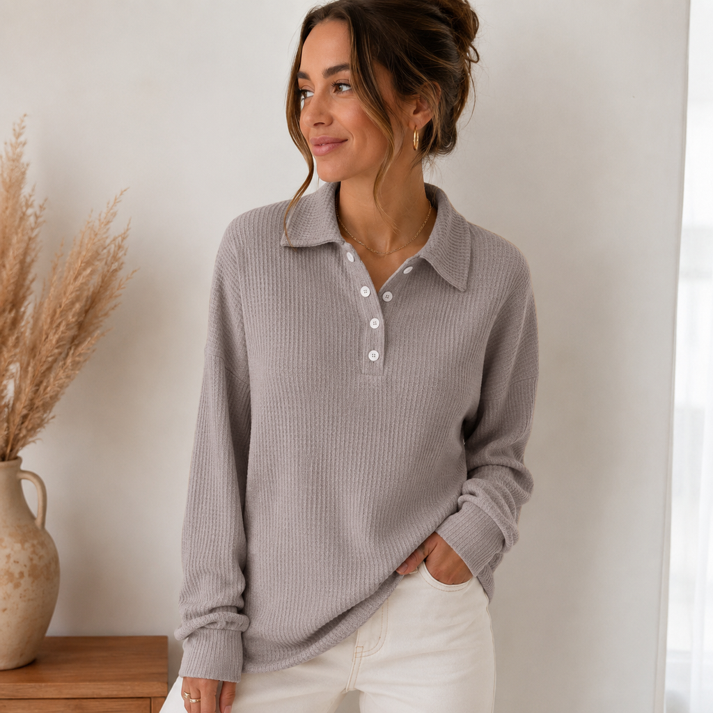 Woman wearing a taupe ribbed knit polo sweater with a button-front collar, long sleeves, and a relaxed fit.