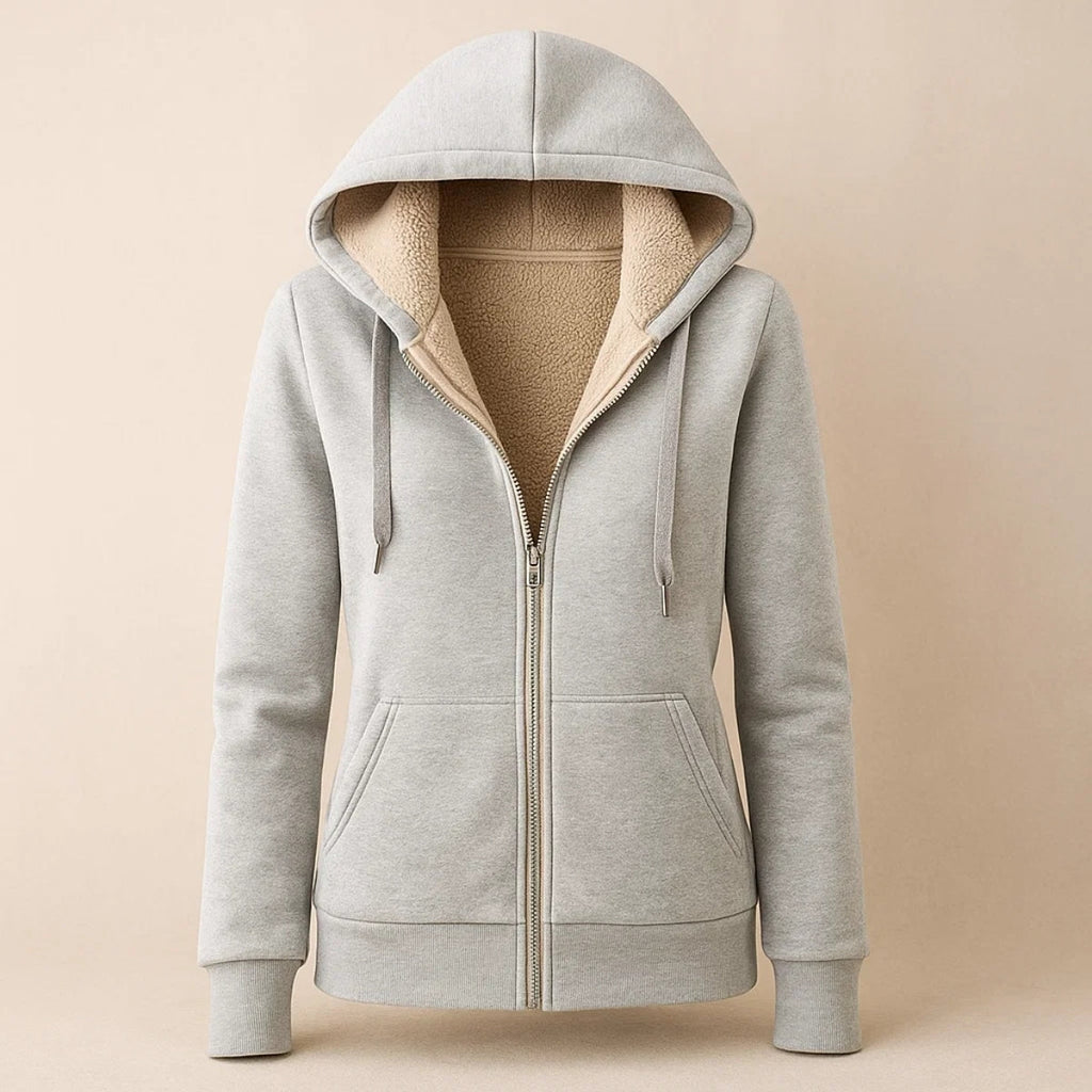 Light gray sherpa-lined hooded jacket with a full zip closure, front pockets, long sleeves, and plush cream interior lining.