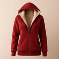 Red sherpa-lined hooded jacket with a full zip closure, front pockets, long sleeves, ribbed cuffs, and plush cream interior lining.