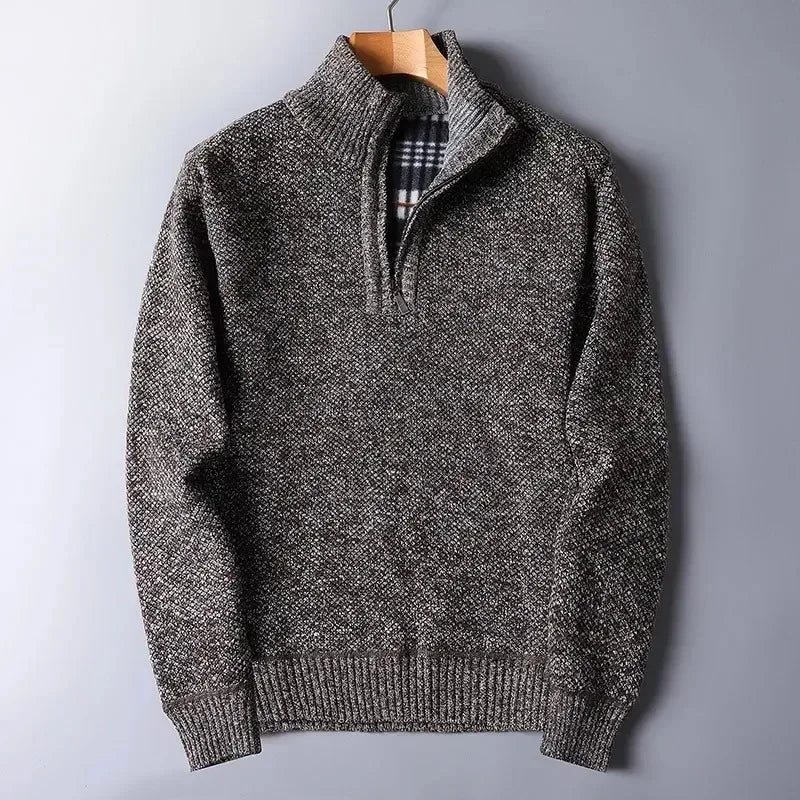 Brown heathered knit quarter-zip sweater with a mock neck, ribbed hem, and a plaid-lined interior on a wooden hanger.