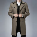 Taupe double-breasted trench coat with wide notch lapels, shoulder epaulettes, and button cuffs in a structured fit.