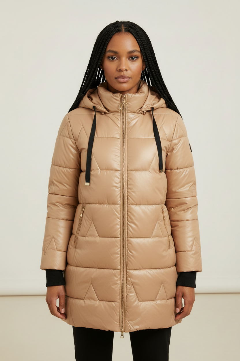 Beige longline puffer coat with quilted padding, a drawstring hood, and full-length zip front, worn over black leggings.