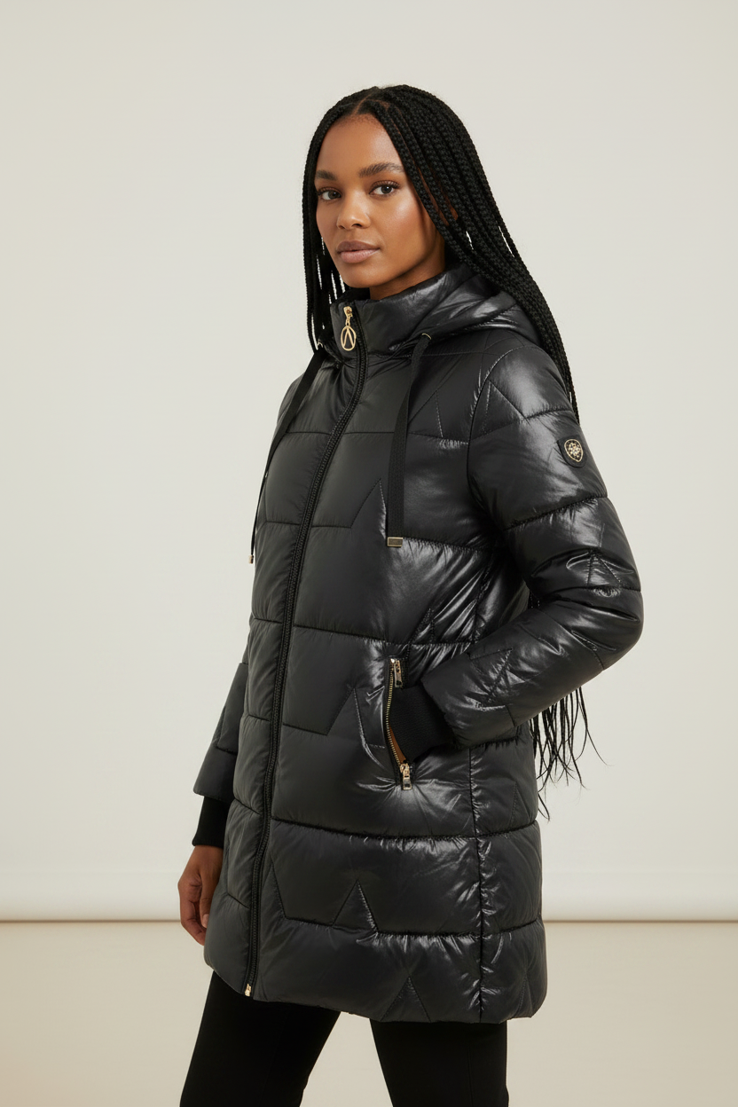 Black longline puffer coat with quilted padding, drawstring hood, and full-length zip front on a model.