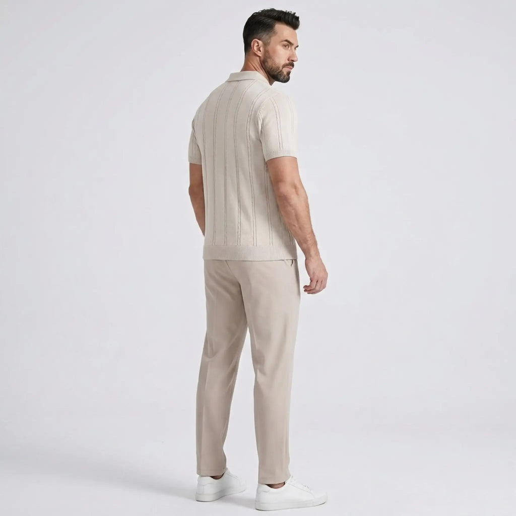 Side view of a man wearing a beige textured knit polo shirt paired with beige trousers.