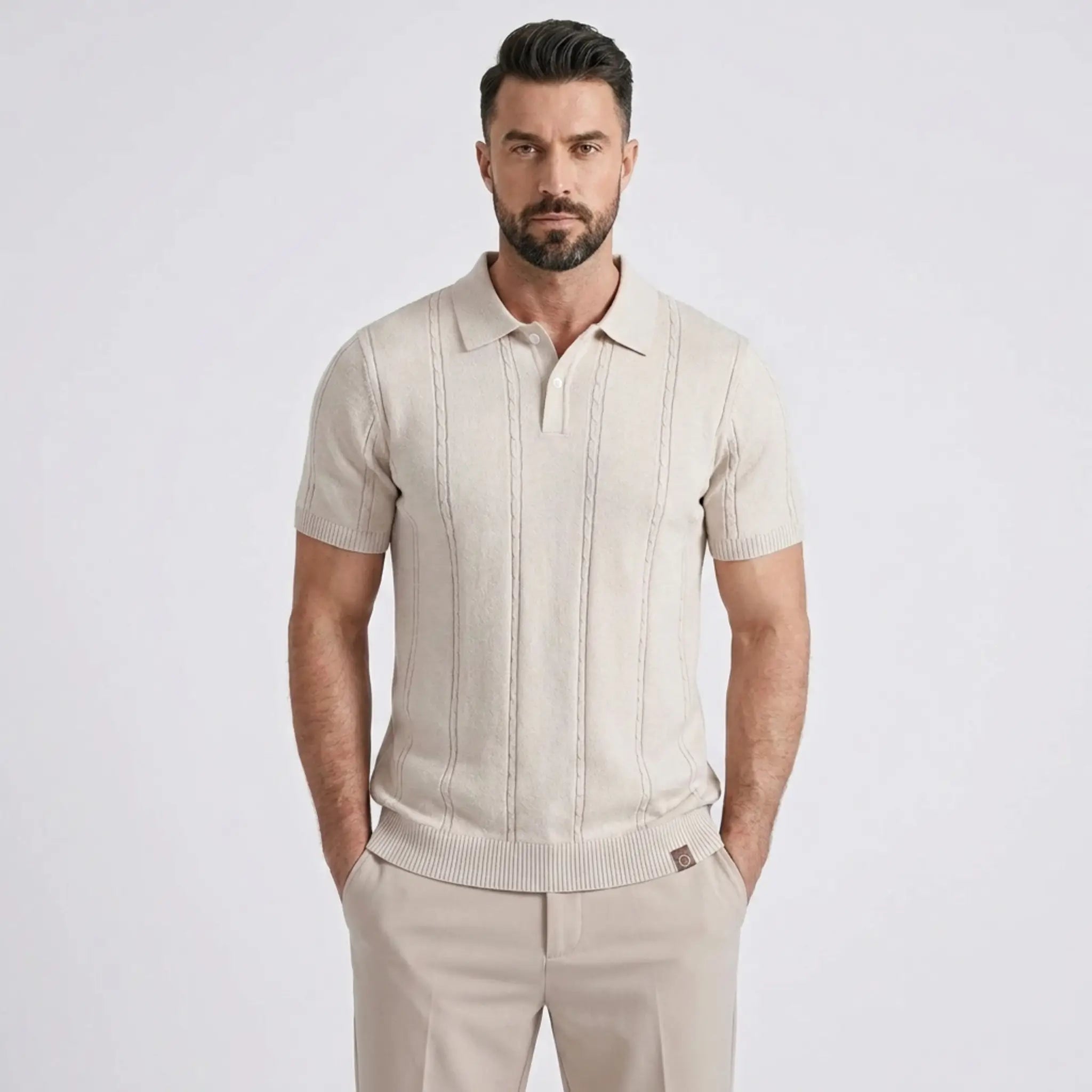 Close-up of a man wearing a beige short-sleeve knit polo shirt with a classic collar.