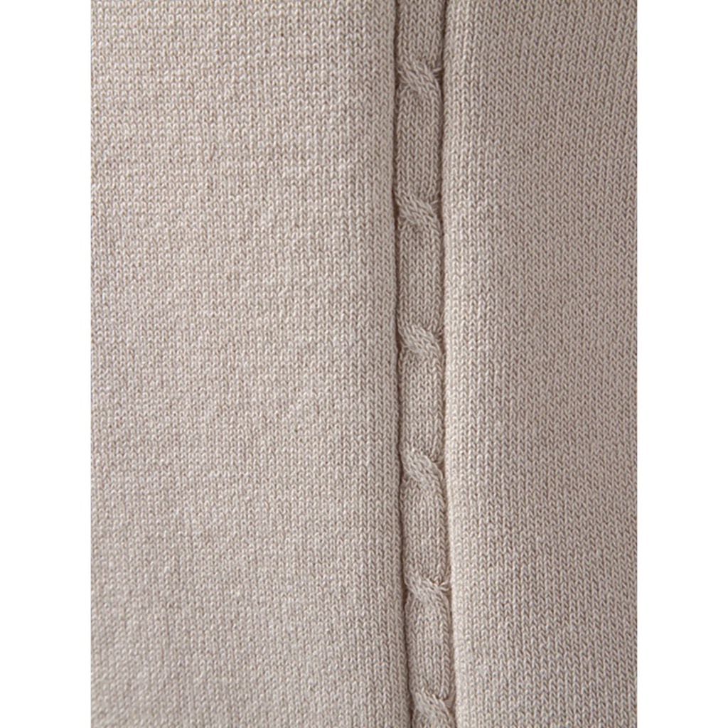 Close-up of the beige textured knit fabric highlighting the soft weave and premium finish.