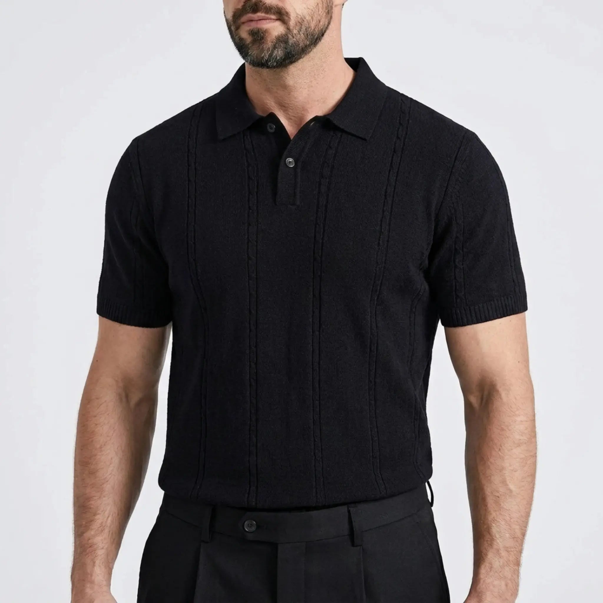 Close-up of a man wearing a black textured knit polo shirt with a classic collar.