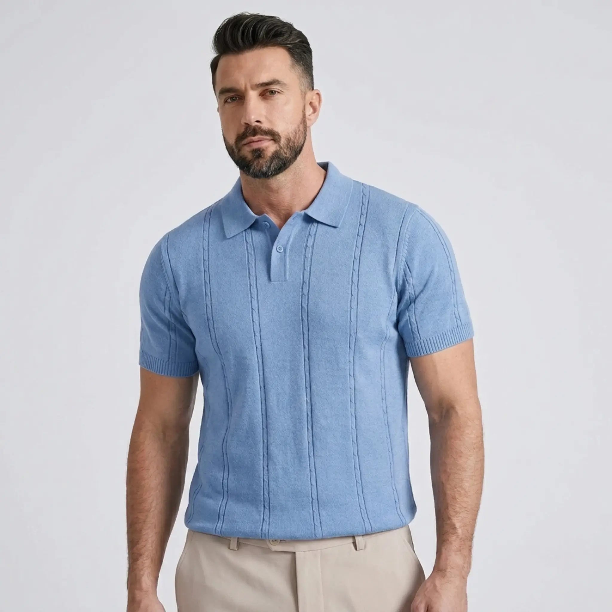 Close-up of a man wearing a light blue textured knit polo shirt with a classic collar.