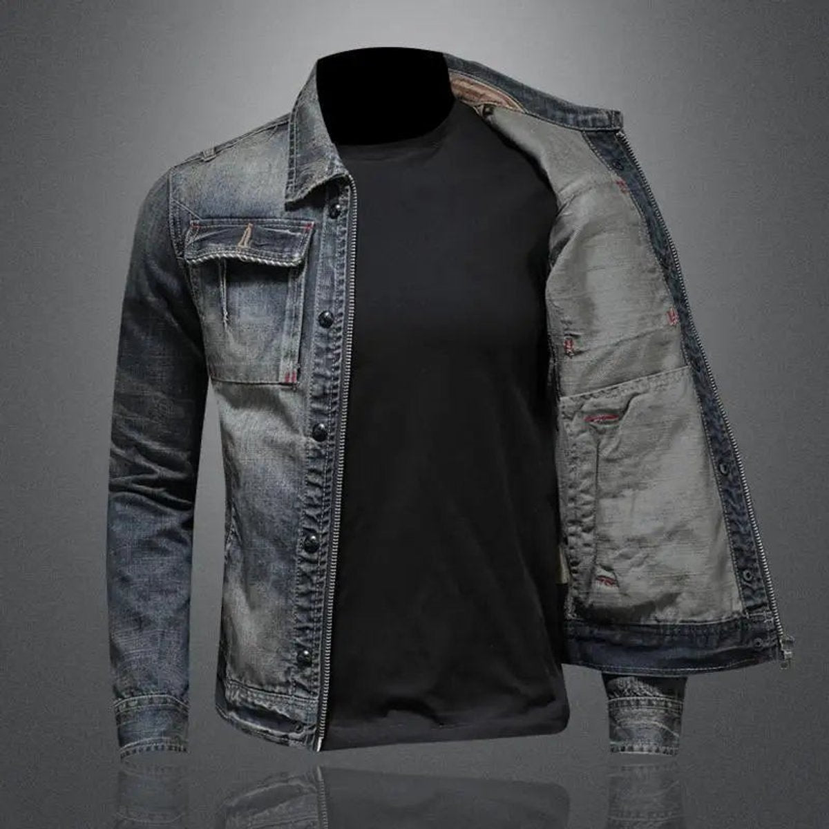 Men's vintage wash denim jacket worn open over a black crew neck T-shirt, featuring a button-front design and faded denim finish.