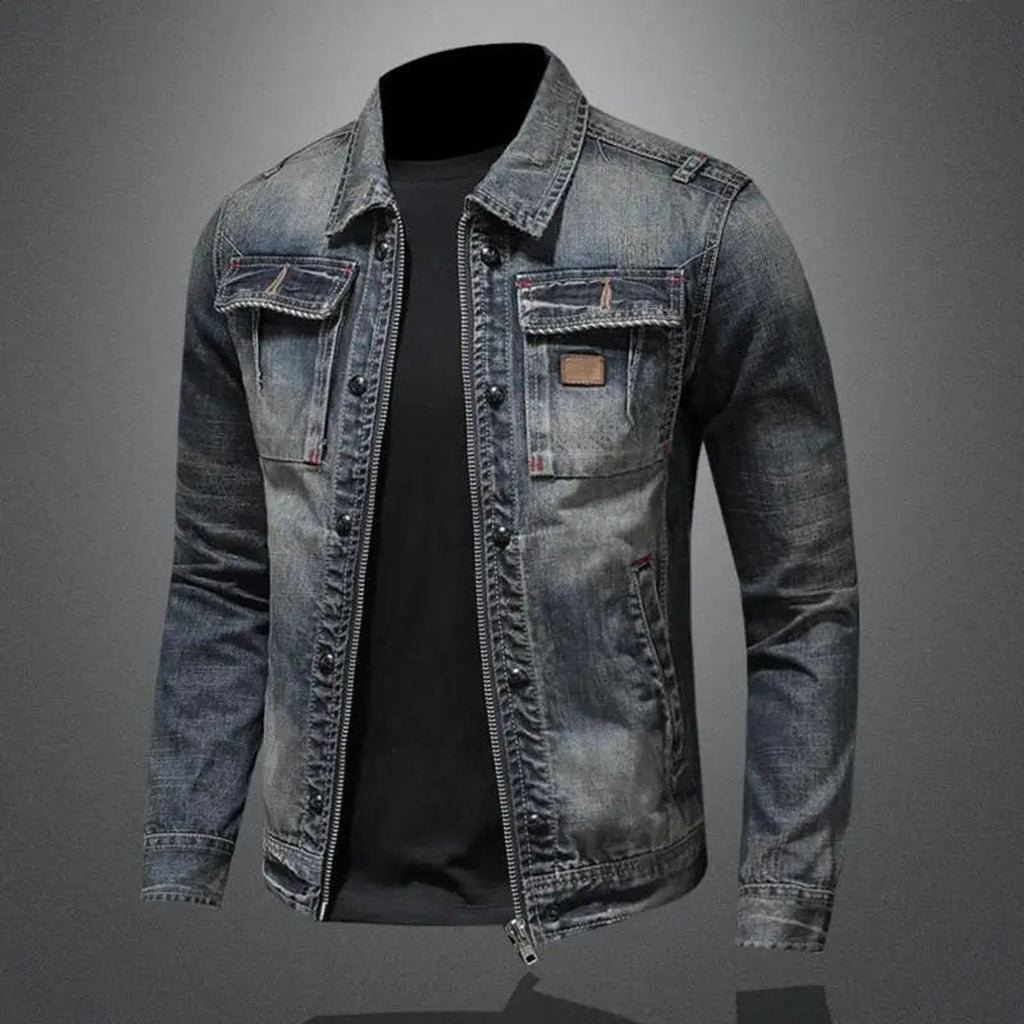 Men's vintage wash denim jacket with a button-front closure, pointed collar, chest flap pockets, and distressed faded detailing.