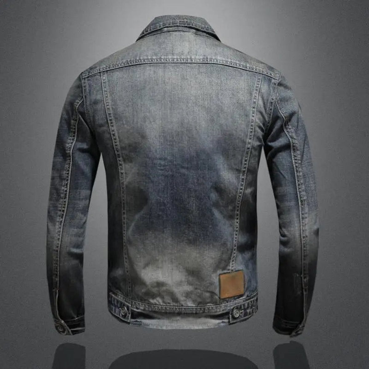 Back view of a men's vintage wash denim jacket featuring a faded finish, structured seams, and classic trucker silhouette.