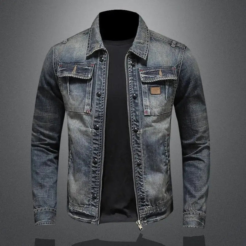 Men's vintage wash denim jacket with a button-front closure, chest flap pockets, faded finish, and regular-fit silhouette over a black T-shirt.