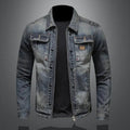 Men's vintage wash denim jacket with a button-front closure, chest flap pockets, faded finish, and regular-fit silhouette over a black T-shirt.