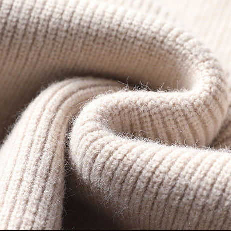 Close-up of beige knit sweater rolled cuff texture
