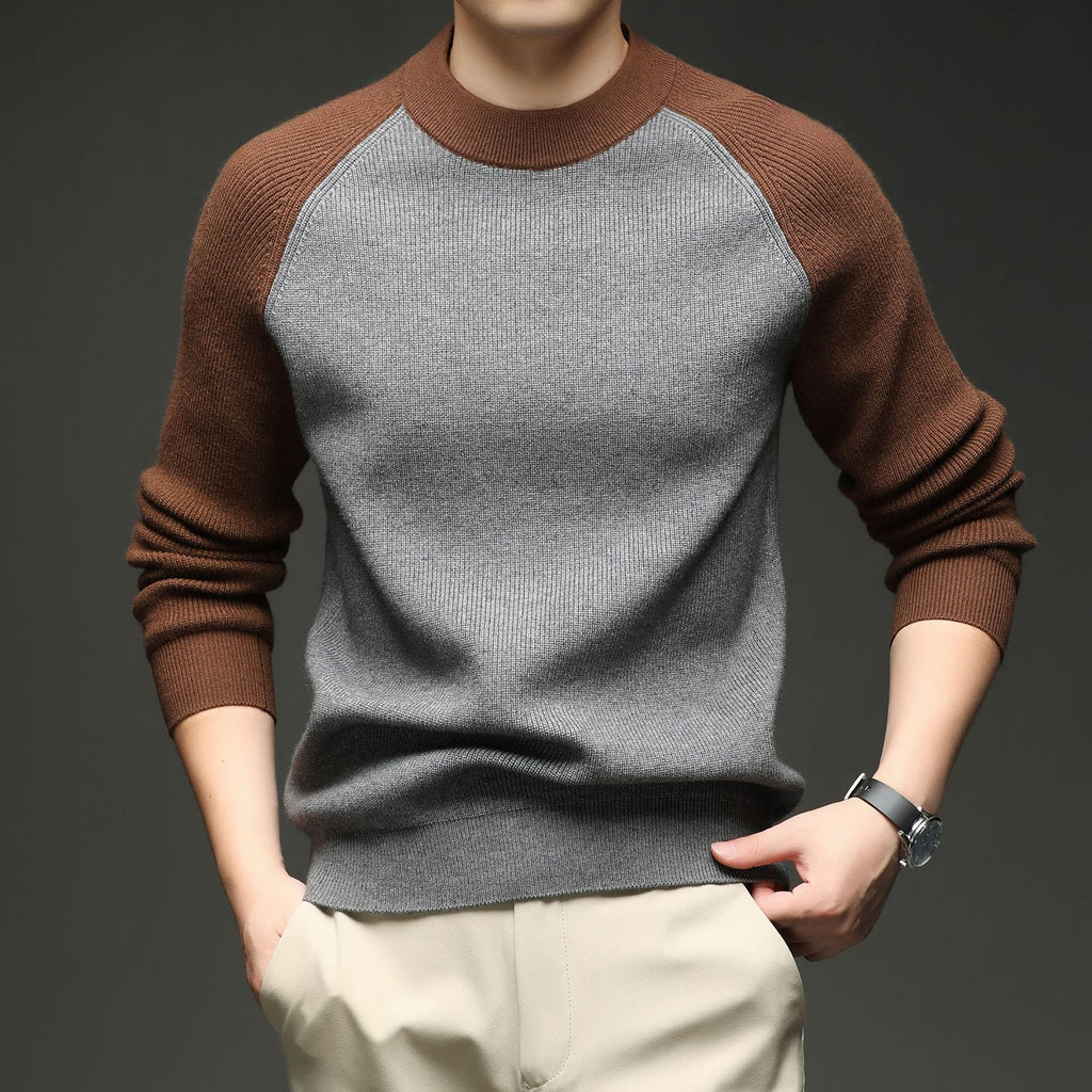 Man wearing grey and brown colorblock raglan knit sweater, close-up torso view
