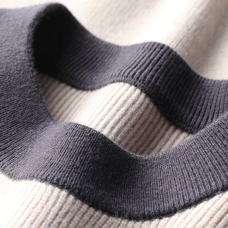 Close-up of navy and cream folded knit sweater fabric texture