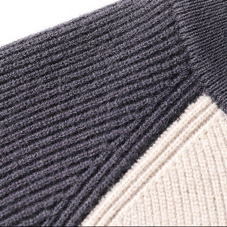 Close-up of navy and cream knit sweater diagonal ribbed seam detail
