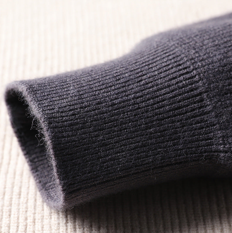 Close-up of charcoal knit sweater rolled cuff detail