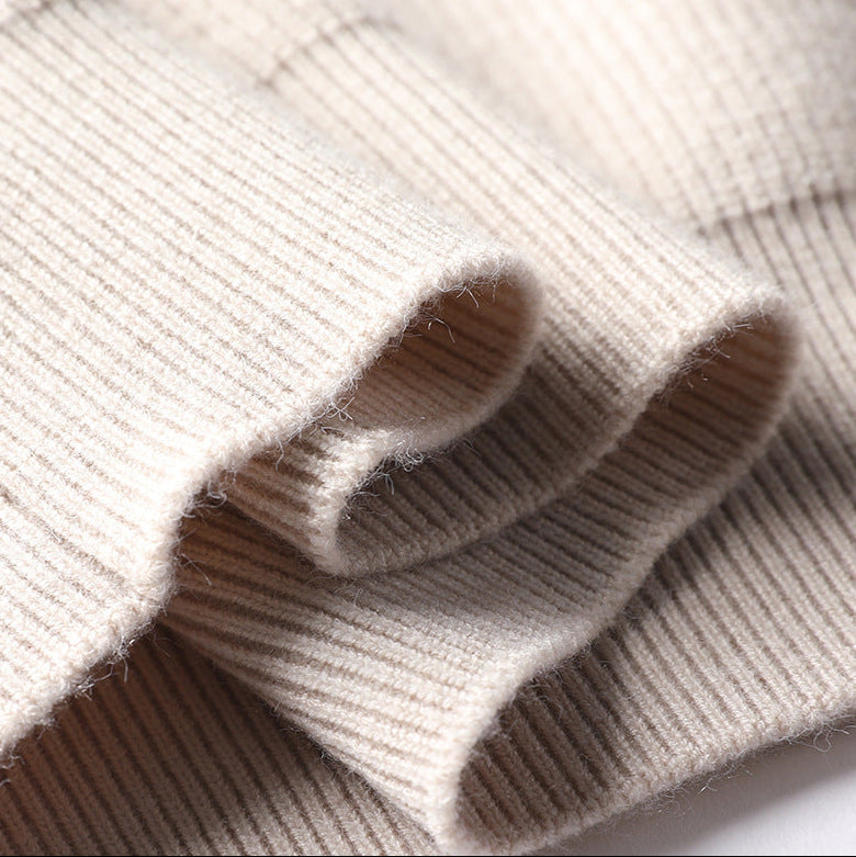 Close-up of cream knit sweater ribbed cuff folds