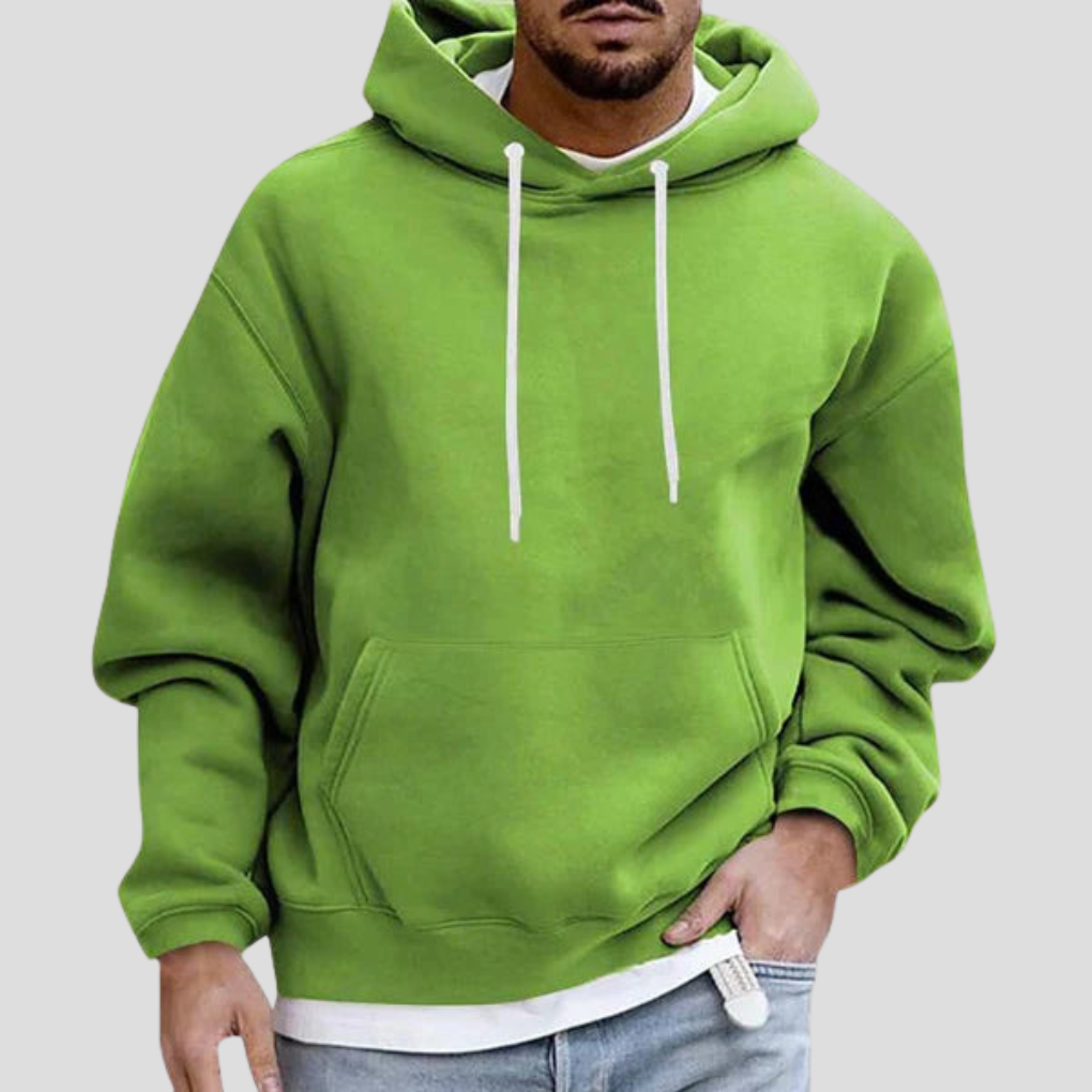 Green pullover hoodie on model, close-up front view with hand in pocket
