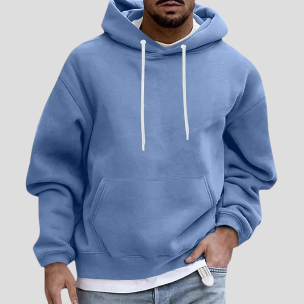 Light blue pullover hoodie on model, close-up front view with hand in pocket