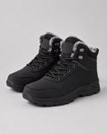 Black lug sole ankle boots with plush-lined collars and lace-up closures, shown in a three-quarter view