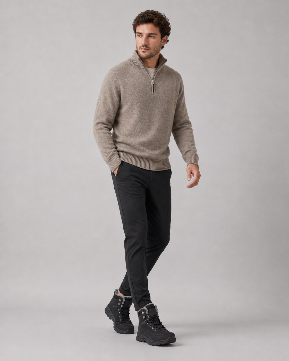 Black lug sole ankle boots with a plush-lined collar and lace-up closure worn by a male model
