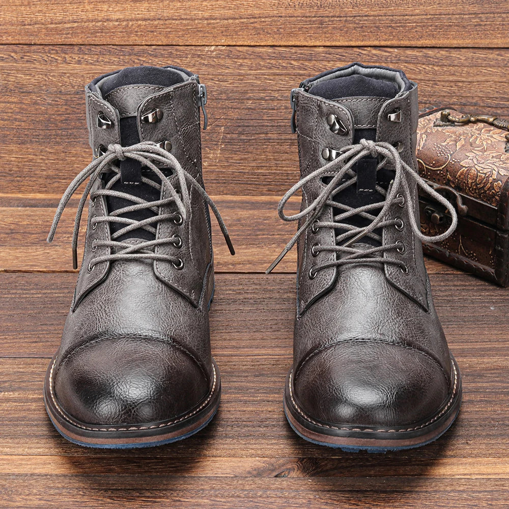 Gray lug sole ankle boot close-up showing the textured leather upper and reinforced toe