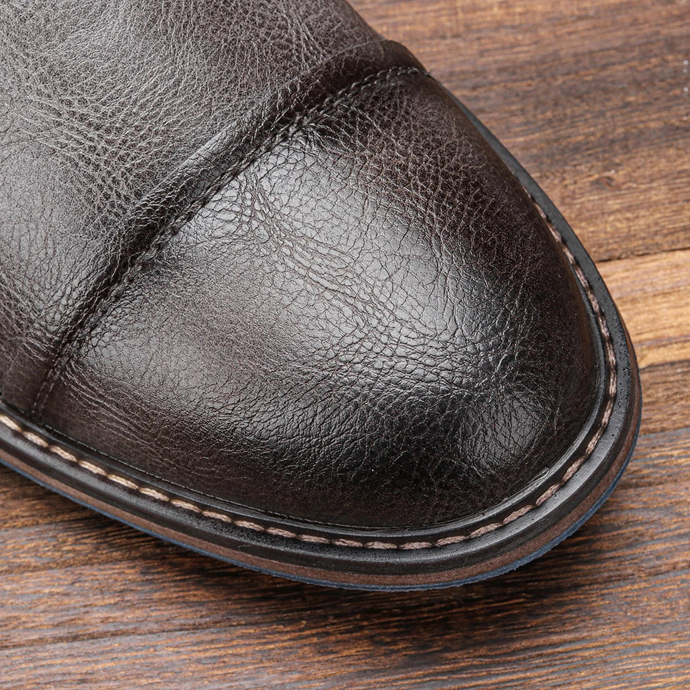 Brown lug sole ankle boot close-up showing the textured leather upper and reinforced toe