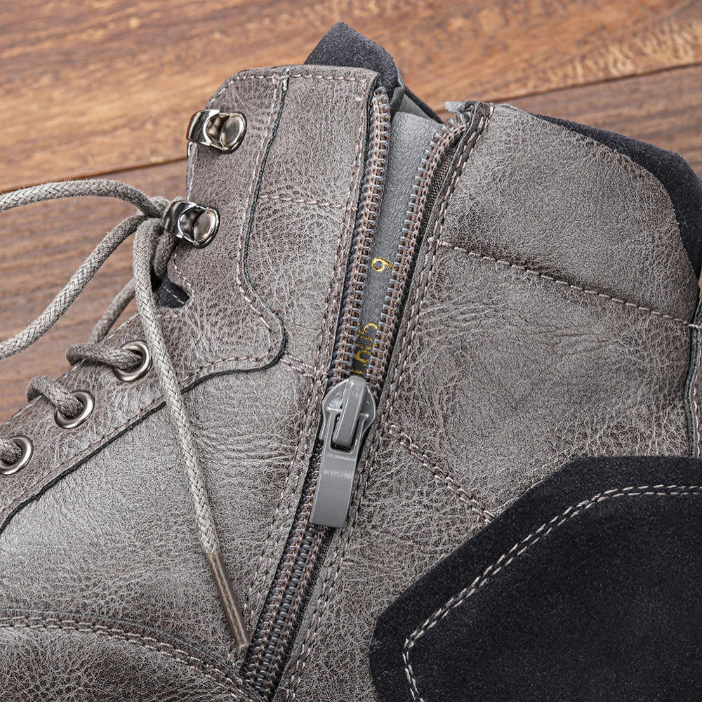 Gray lug sole ankle boot close-up showing the side zipper, lace-up closure, and warm lining
