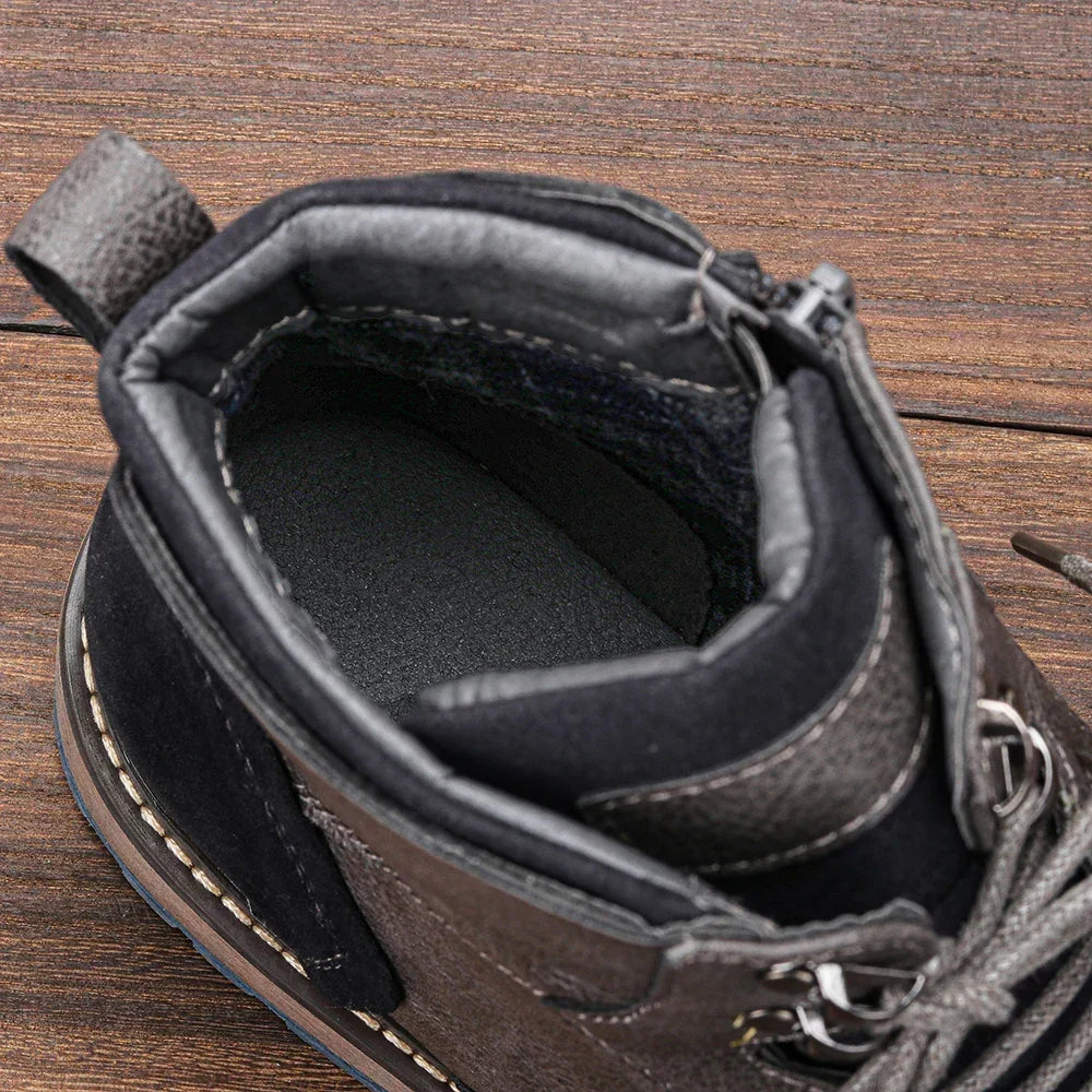 Black lug sole ankle boot close-up showing the padded collar and warm lining