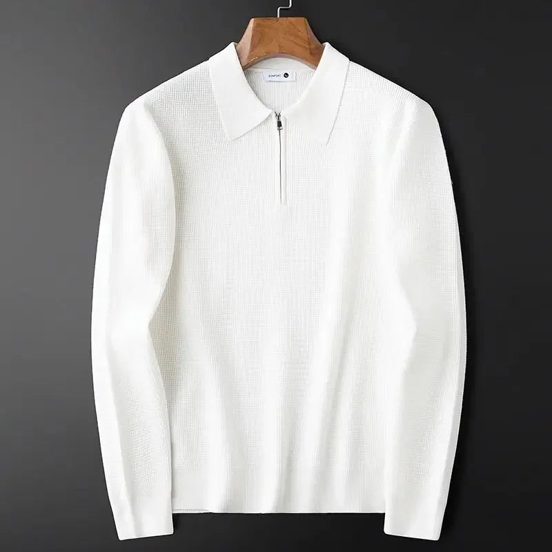 White textured half-zip polo sweater with a ribbed collar and long sleeves displayed on a wooden hanger.
