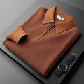 Brown textured half-zip polo sweater with a ribbed collar and long sleeves, neatly folded beside a wristwatch on a dark surface.
