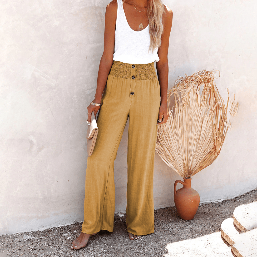 Women's mustard yellow high-waisted wide-leg linen pants featuring front buttons, a loose fit, and lightweight fabric.