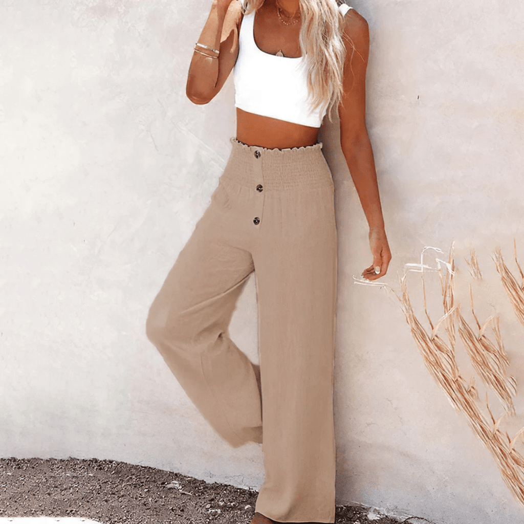 Women's beige high-waisted wide-leg linen pants with decorative front buttons, a relaxed silhouette, and side pockets.