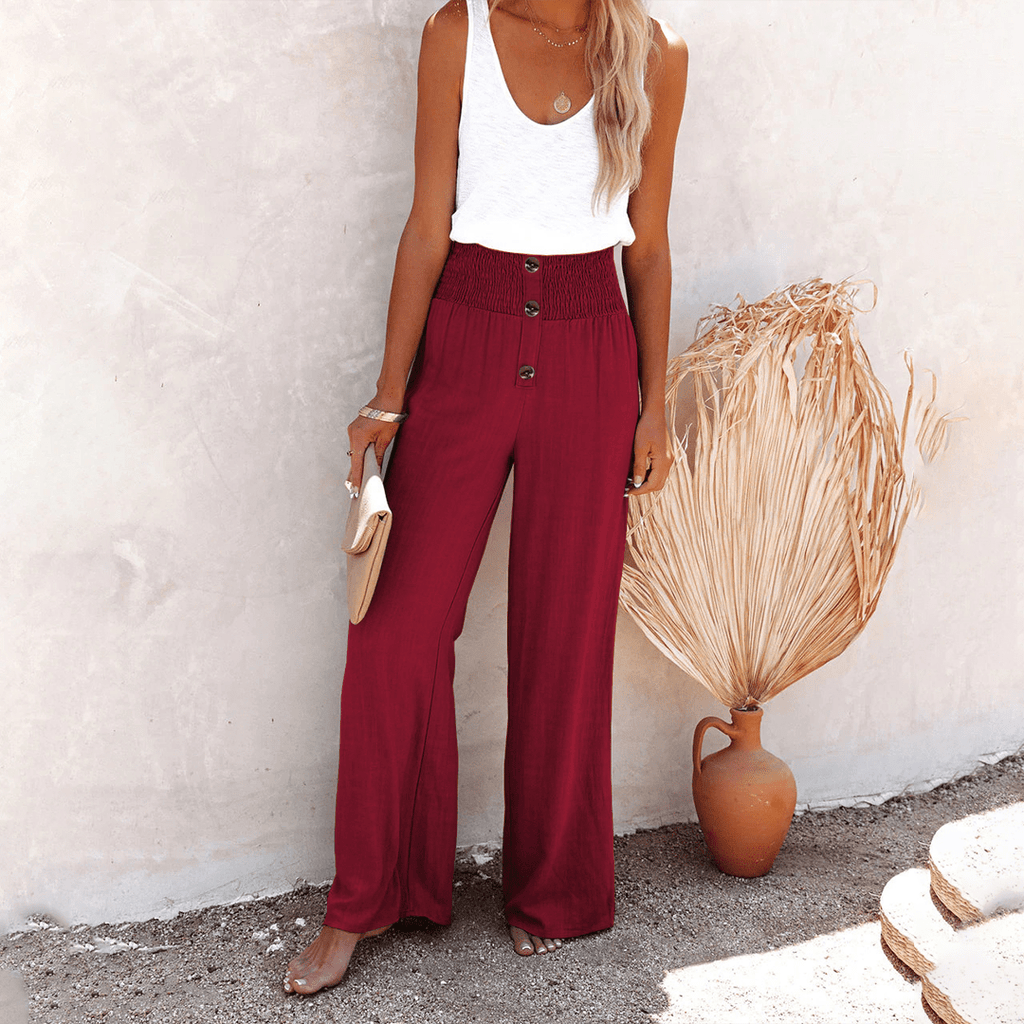 Women's burgundy high-waisted wide-leg linen pants with decorative front buttons, a relaxed fit, and soft drape.