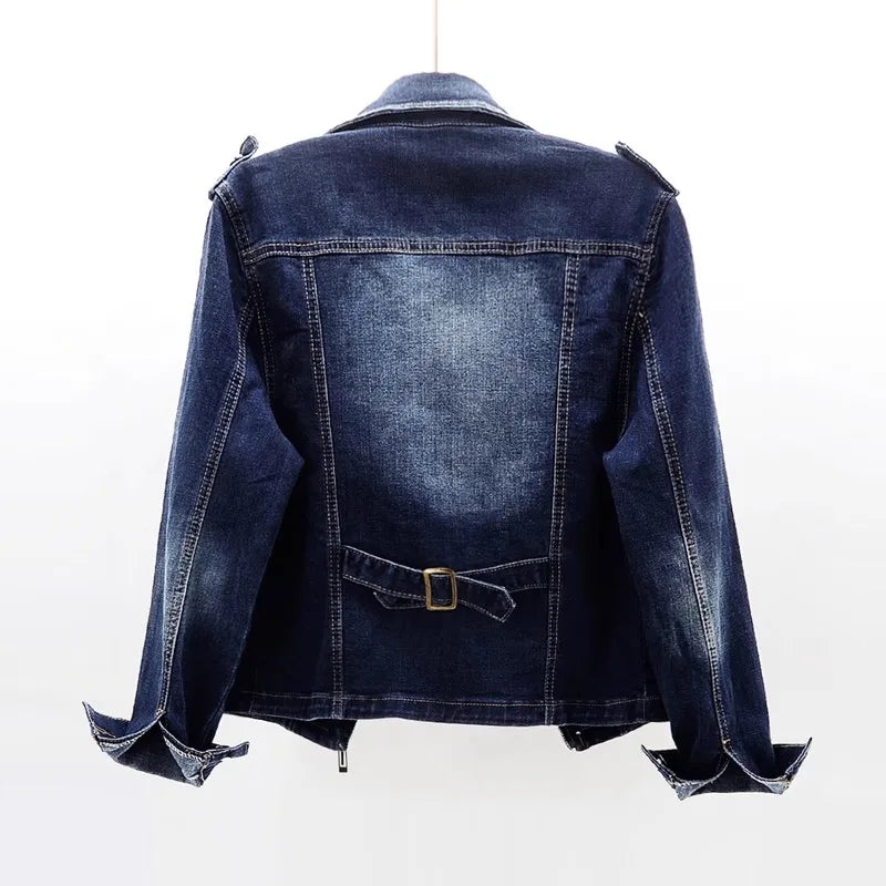 Back view of a women's dark blue denim moto jacket featuring a faded wash, cropped fit, and tailored construction.