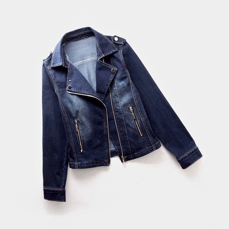 Folded dark blue women's denim moto jacket with an asymmetrical zipper, cropped design, and classic moto styling.