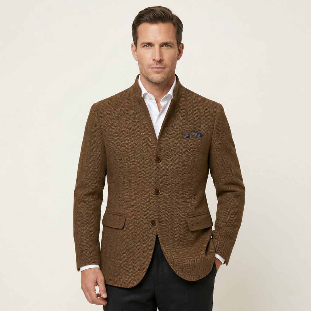 Man wearing a brown textured wool blazer with a stand collar, button closure, flap pockets, and blue pocket square over a light shirt.