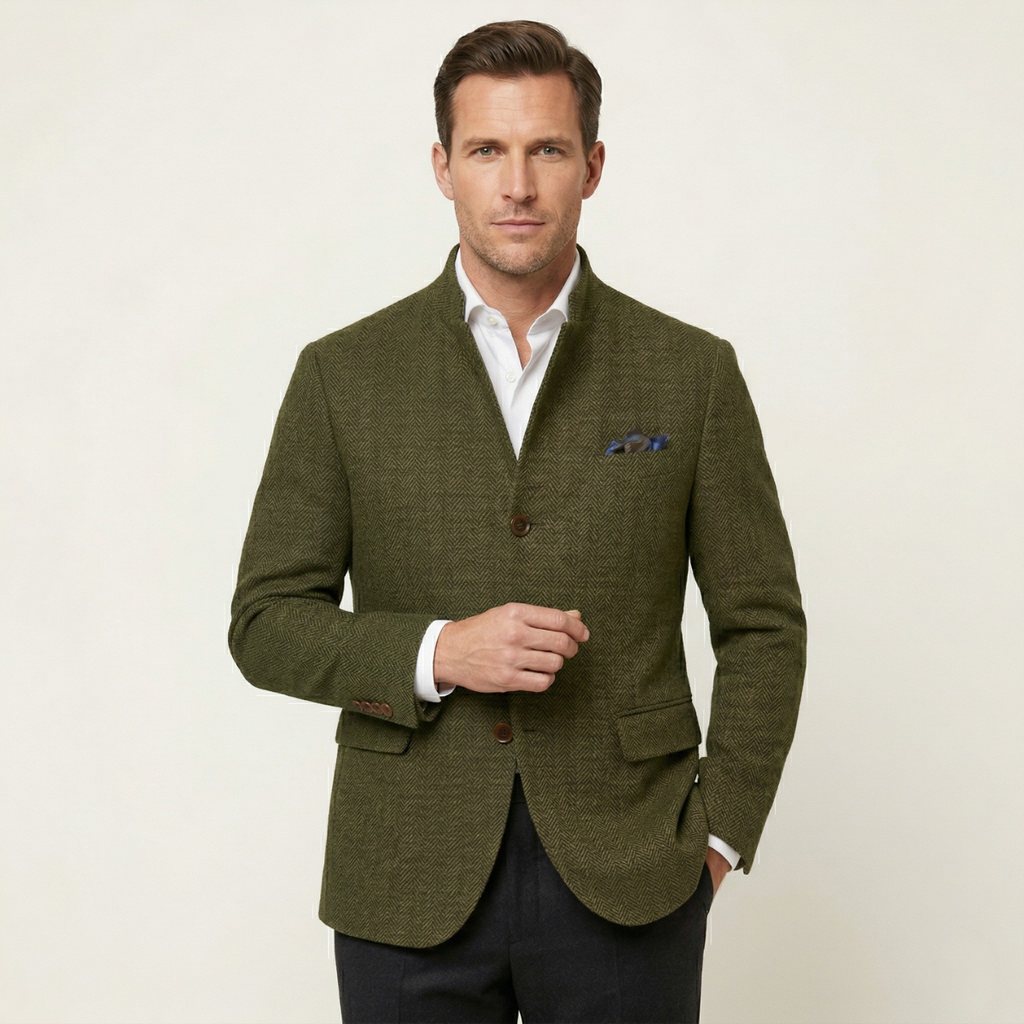 Man wearing an olive green textured wool blazer with a stand collar, button closure, flap pockets, and blue pocket square.