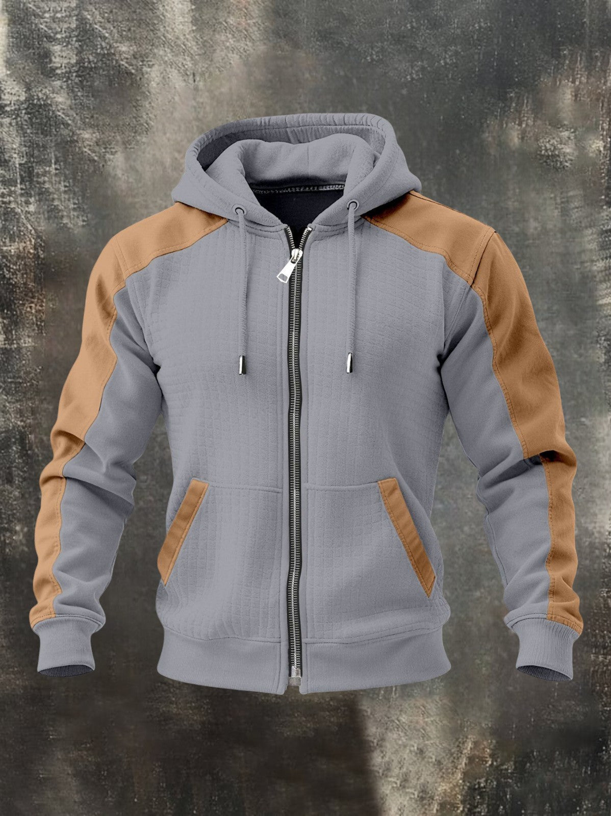 Light gray zip-up hoodie featuring tan raglan sleeves, adjustable hood, front zipper, and kangaroo pockets on a textured background.