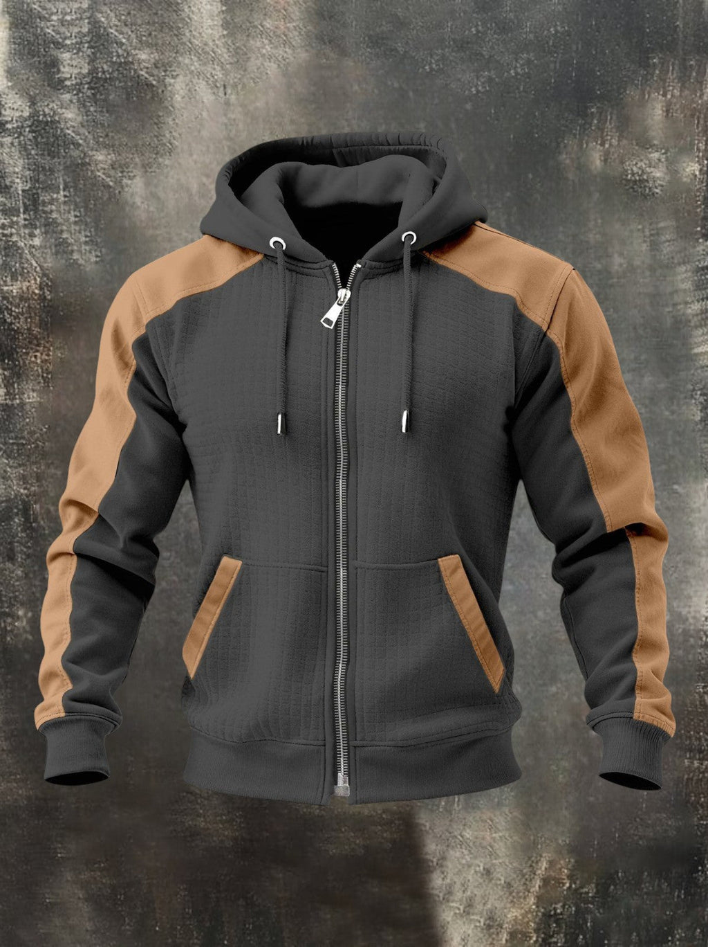 Charcoal gray zip-up hoodie with tan raglan sleeves, adjustable hood, front zipper, and front kangaroo pockets displayed on a textured background.