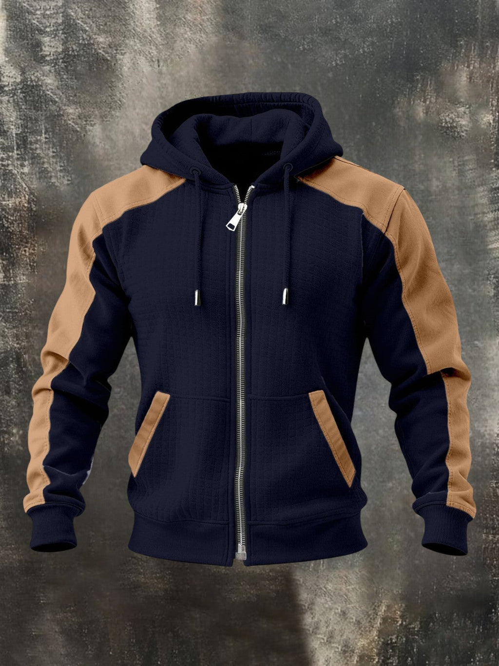 Navy blue zip-up hoodie featuring tan raglan sleeves, adjustable hood, front zipper, and kangaroo pockets on a textured background.