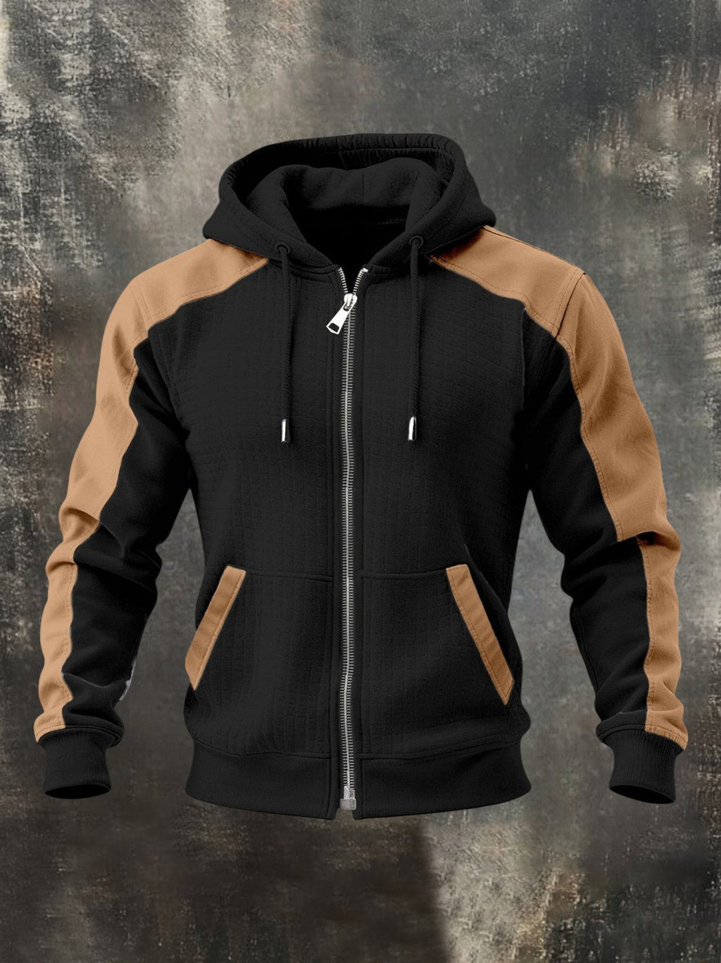 Black zip-up hoodie with tan raglan sleeves, adjustable hood, front zipper, and kangaroo pockets displayed on a textured background.