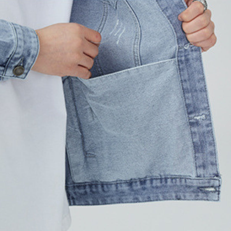 Close-up of the cuff and sleeve on a men's light wash denim jacket featuring button cuffs and durable denim fabric.