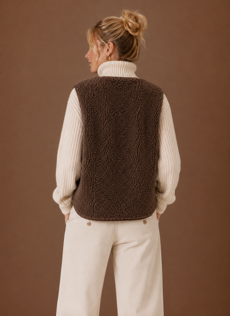 Back view of a women's brown fleece sweater vest featuring a sleeveless silhouette and soft textured fabric.