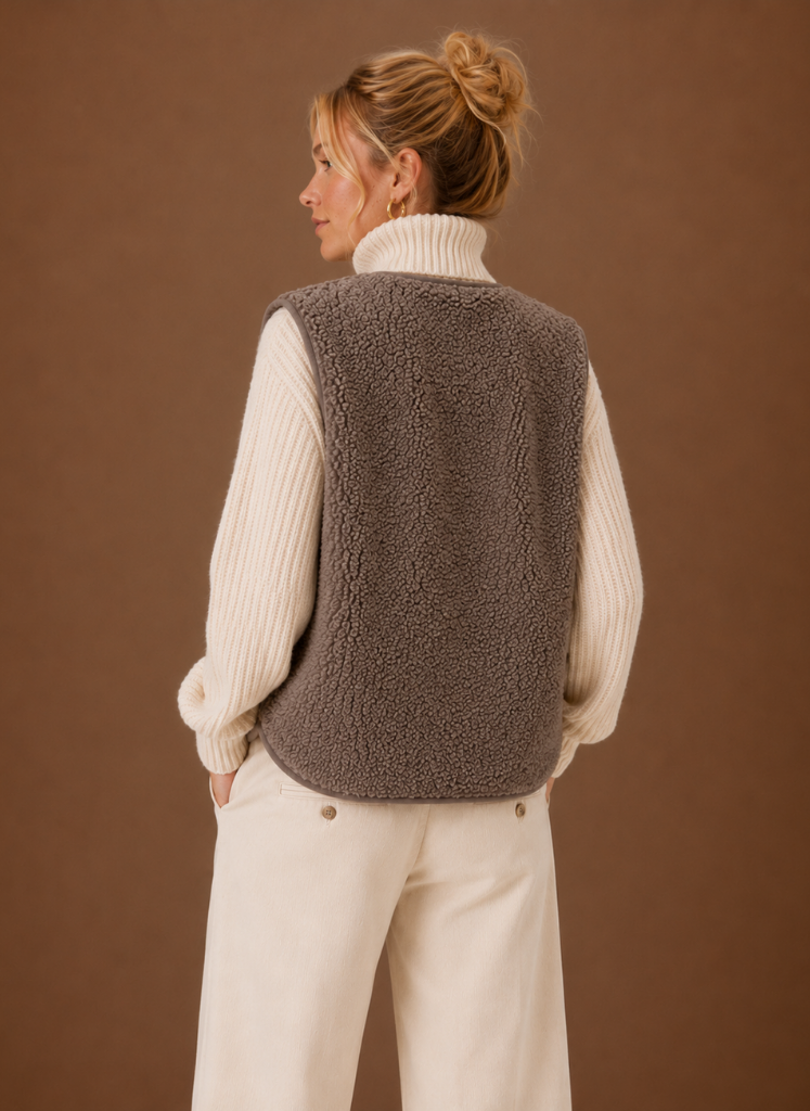 Back view of a women's brown fleece sweater vest with a sleeveless design and soft textured finish.