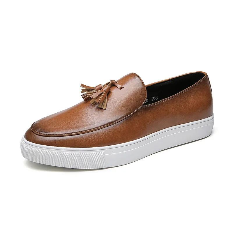 A brown leather tassel loafer with a white sole, shown in side profile on a plain white background.