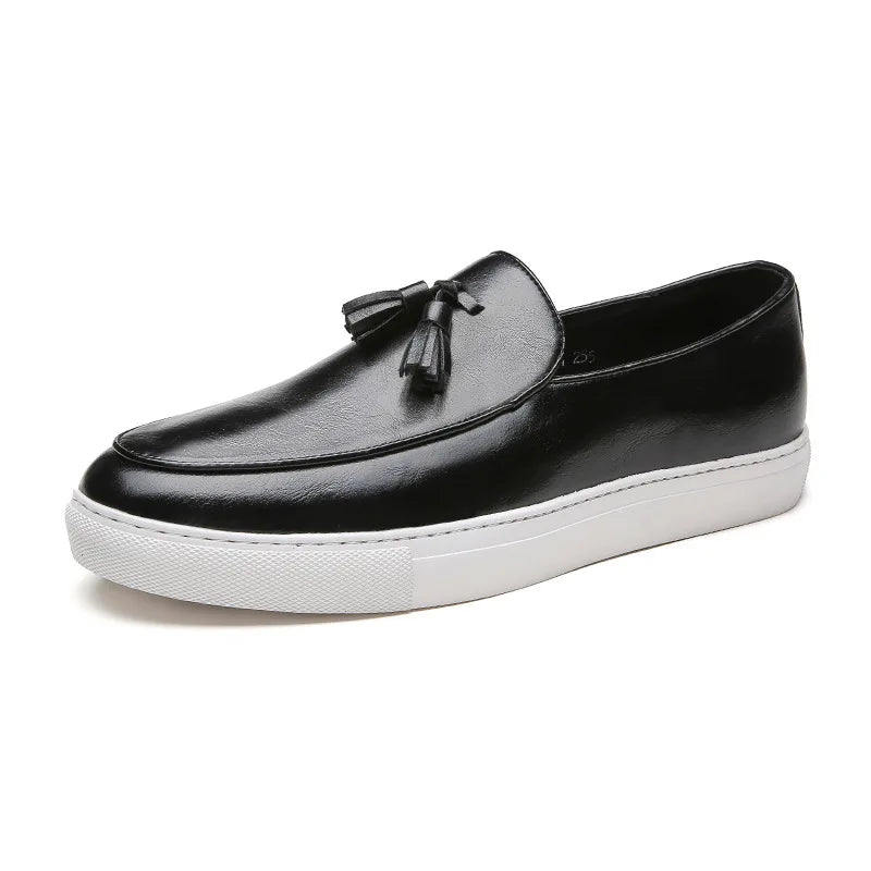 A black leather tassel loafer with a white sole, shown in side profile on a plain white background.