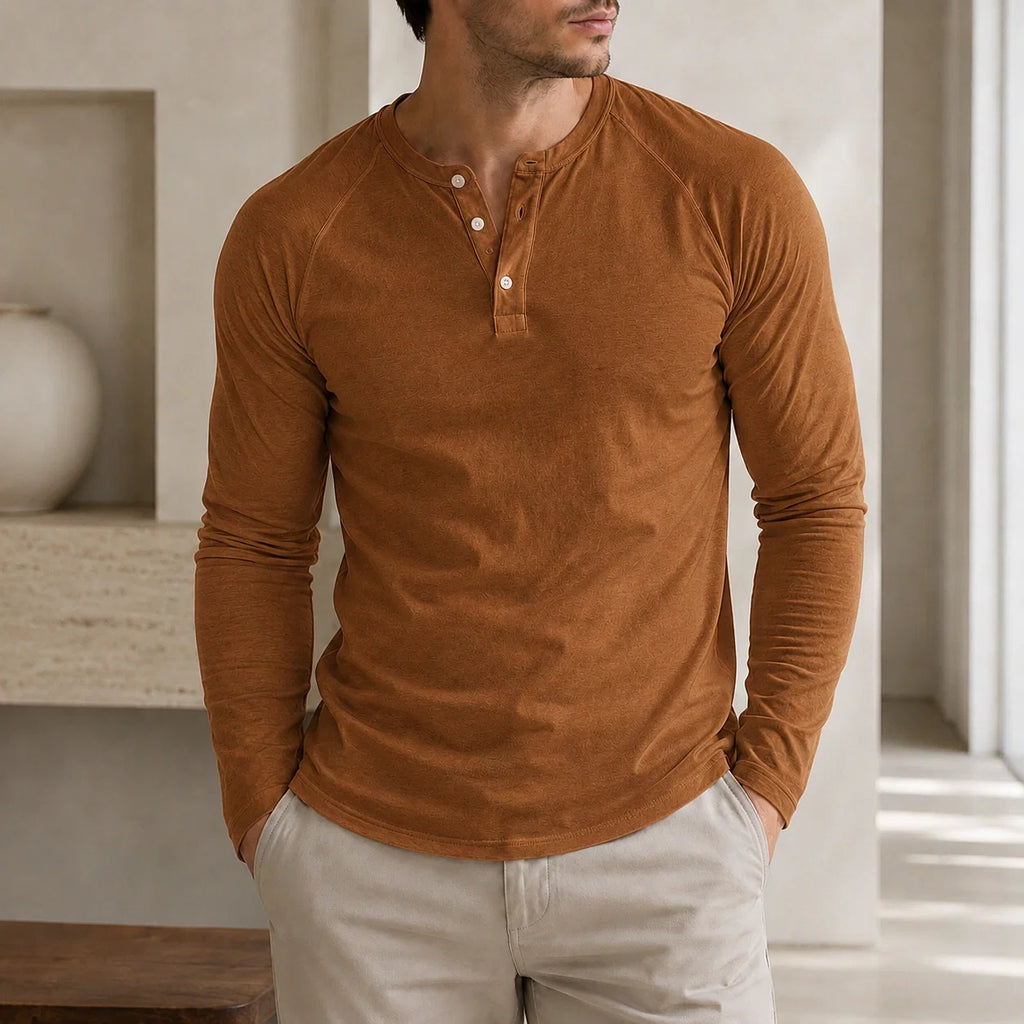 Man wearing a brown long-sleeve Henley sweater featuring a three-button placket, ribbed cuffs, and a fitted silhouette.
